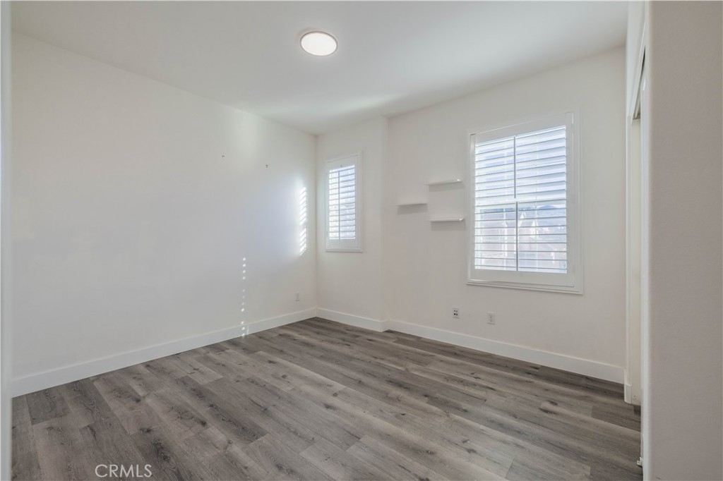 4 Lavanda Street Rancho Mission Viejo, CA 92694 - Photo 30 of 43 an empty room with wooden floor and windows