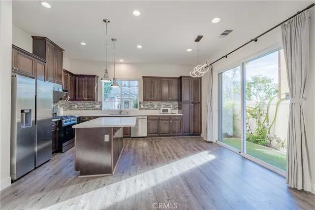 a kitchen with a refrigerator sink and cabinets