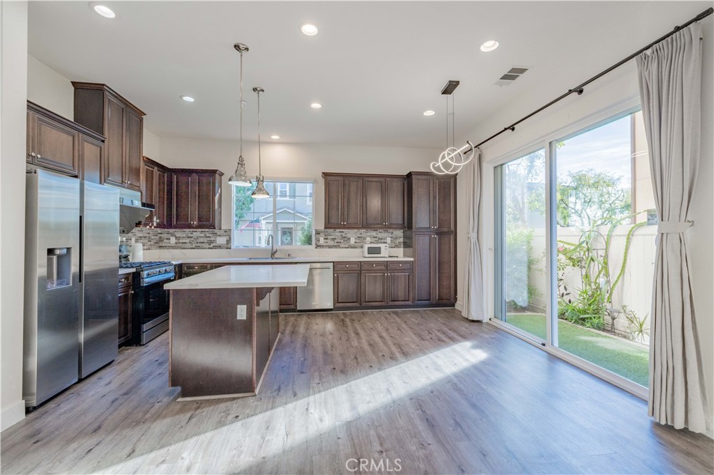 4 Lavanda Street Rancho Mission Viejo, CA 92694 - Photo 3 of 43 a kitchen with a refrigerator sink and cabinets
