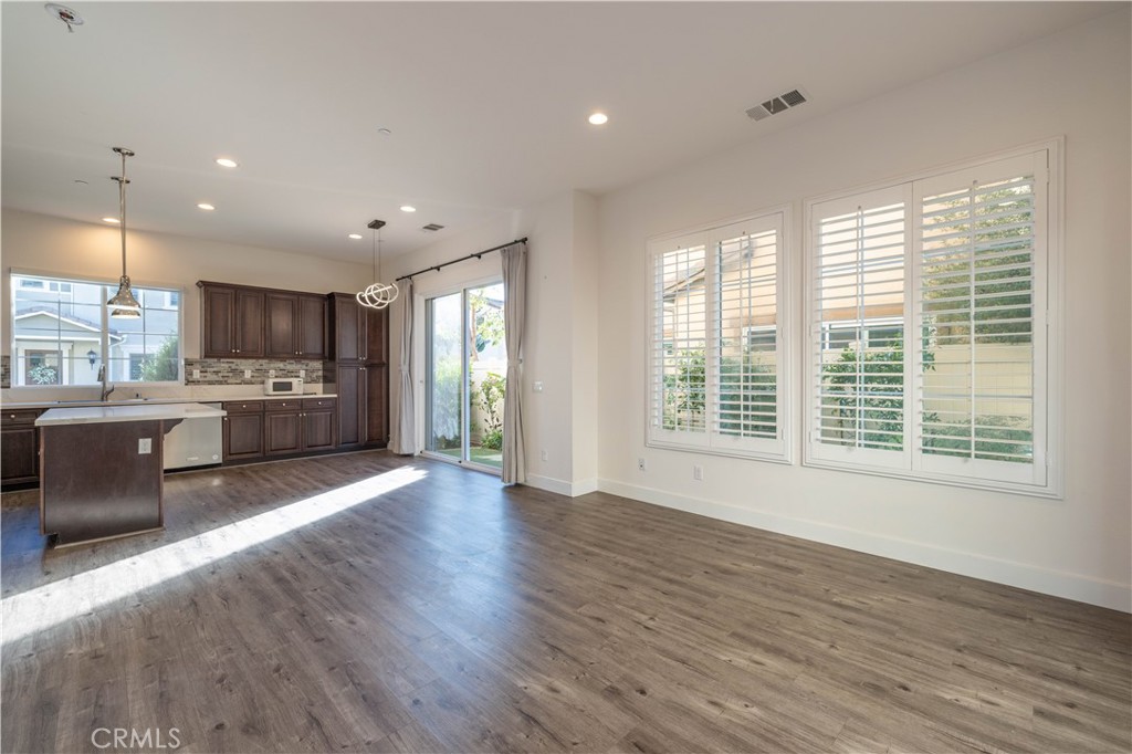 4 Lavanda Street Rancho Mission Viejo, CA 92694 - Photo 8 of 43 a view of kitchen with stainless steel appliances granite countertop a stove a sink a refrigerator with wooden cabinets and wooden floor