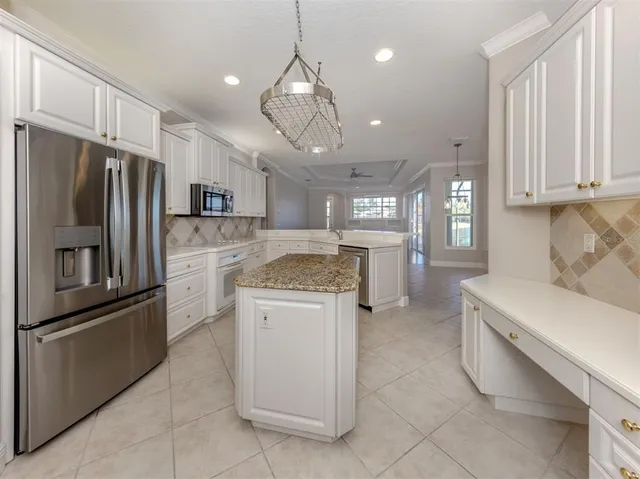a kitchen with appliances a sink and cabinets