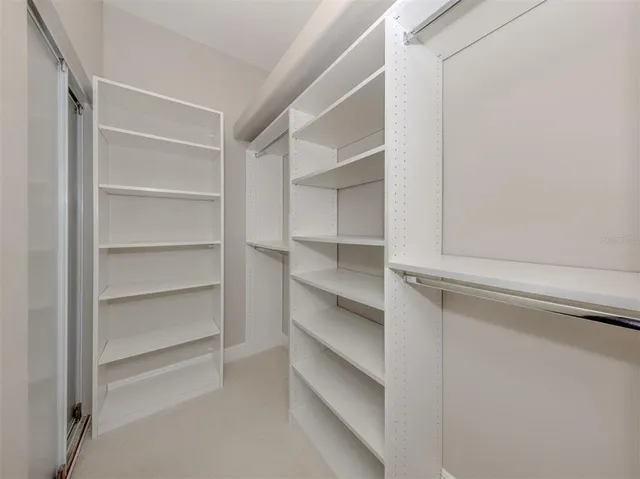 a bathroom with a shower sink vanity mirror and toilet