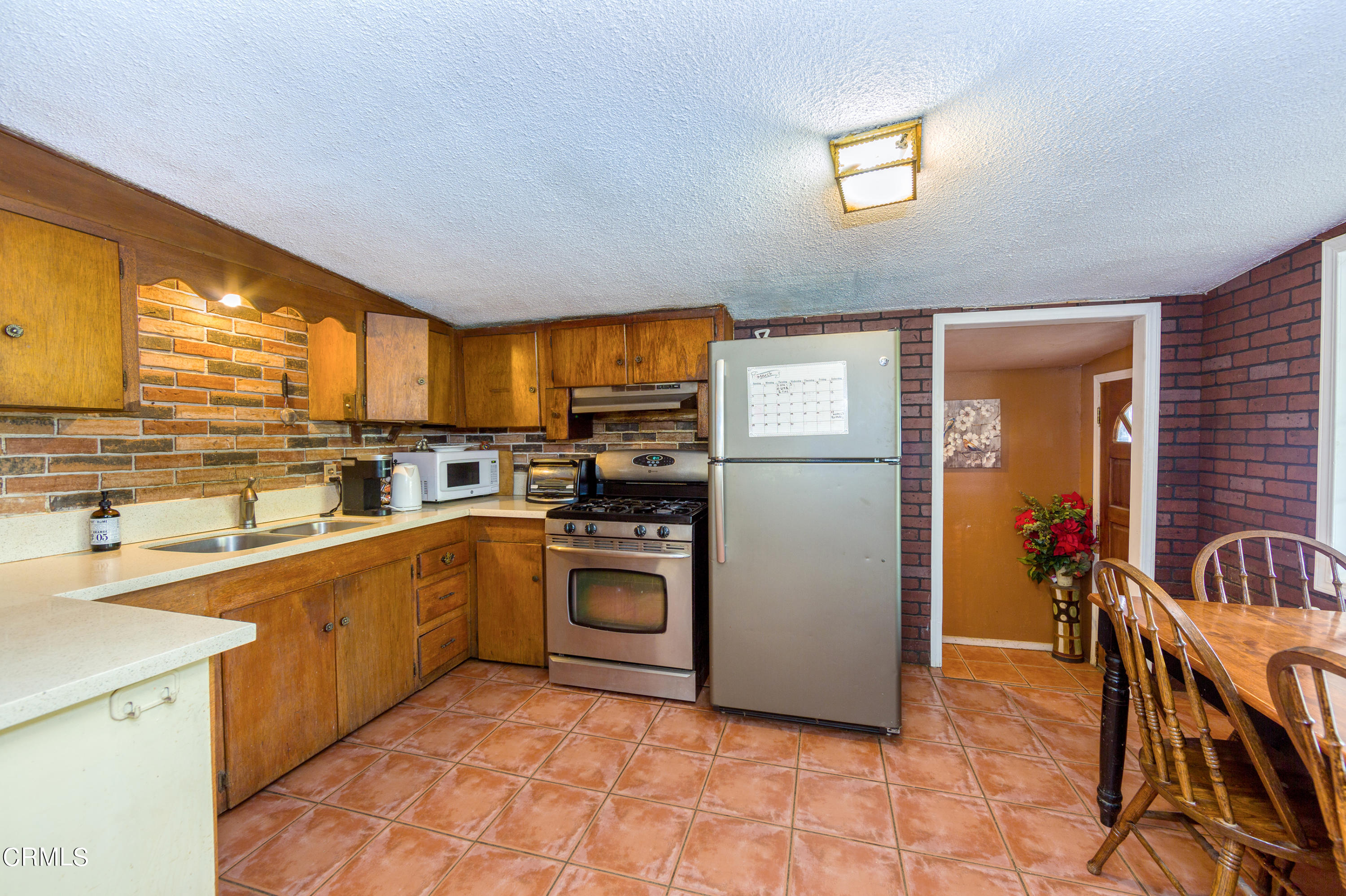 3555 East Telegraph Road Fillmore, CA 93015 - Photo 7 of 21 a kitchen with stainless steel appliances granite countertop a refrigerator and a stove top oven