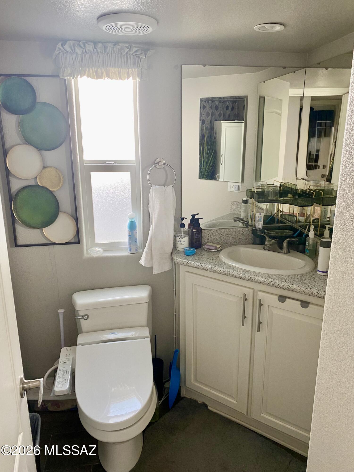 2843 19 Interstate 19 Frontage Road, Unit 116 Amado, AZ 85645 - Photo 15 of 32 a bathroom with a toilet sink and mirror