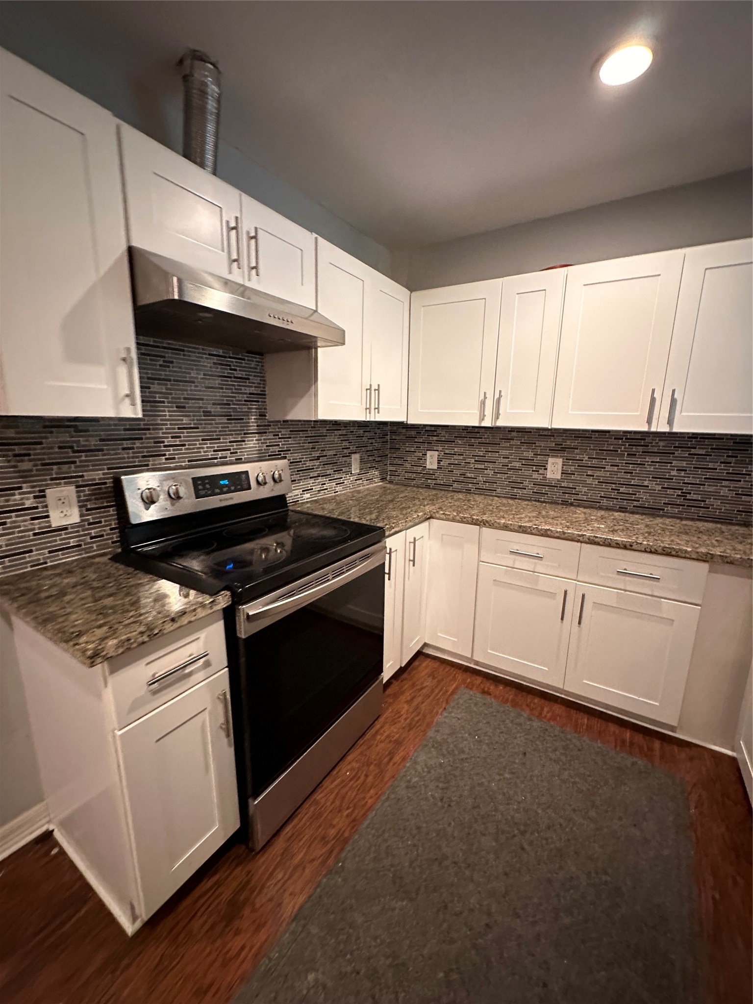 4802 Eppes Street Houston, TX 77021 - Photo 7 of 34 a kitchen with granite countertop a stove sink and cabinets