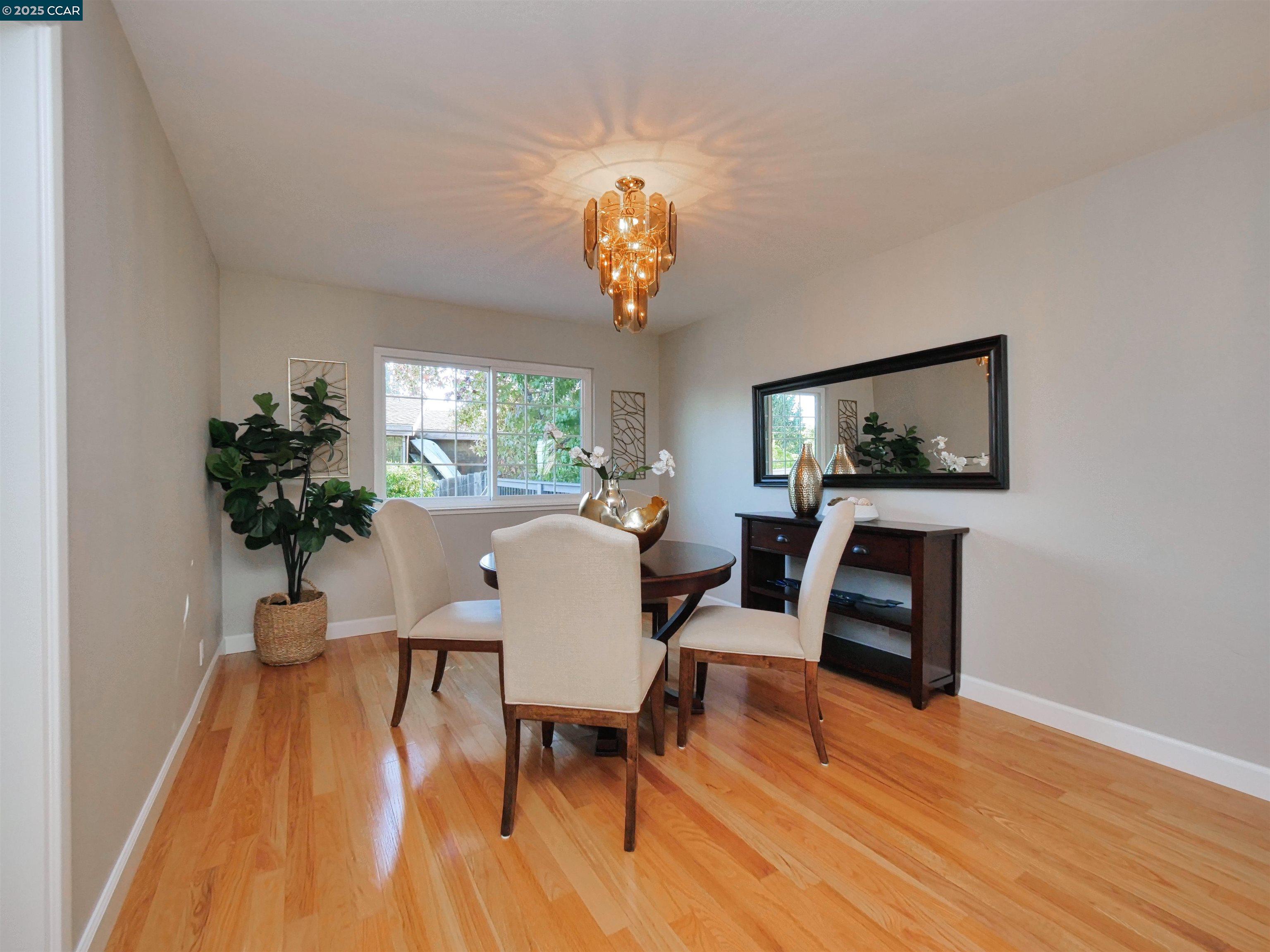 4044 Cowell Road Concord, CA 94518 - Photo 13 of 60 a view of a dining room with furniture a chandelier and wooden floor