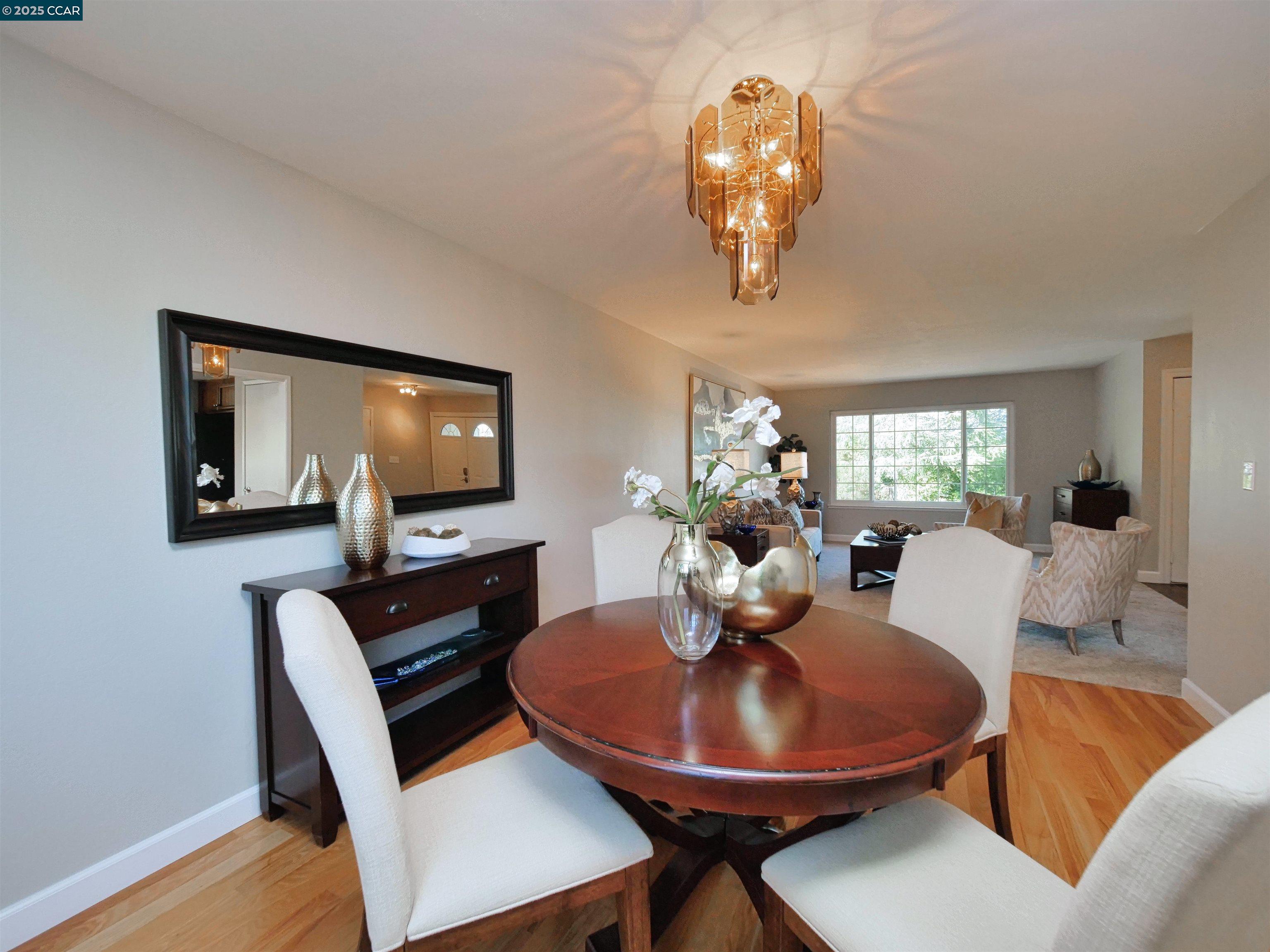 4044 Cowell Road Concord, CA 94518 - Photo 14 of 60 a dining room with furniture a chandelier and wooden floor