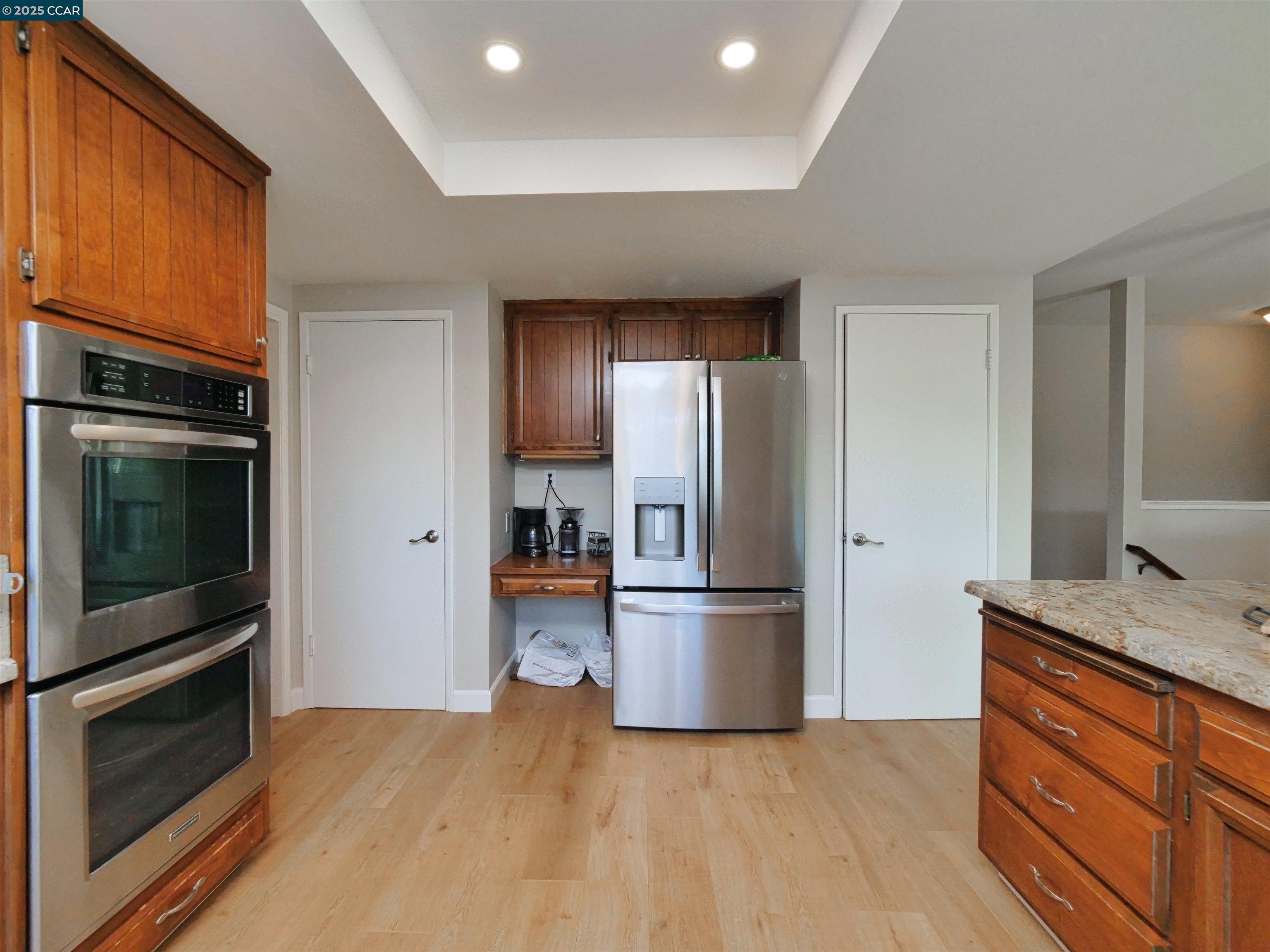 4044 Cowell Road Concord, CA 94518 - Photo 17 of 60 a kitchen with a refrigerator stove and wooden cabinets