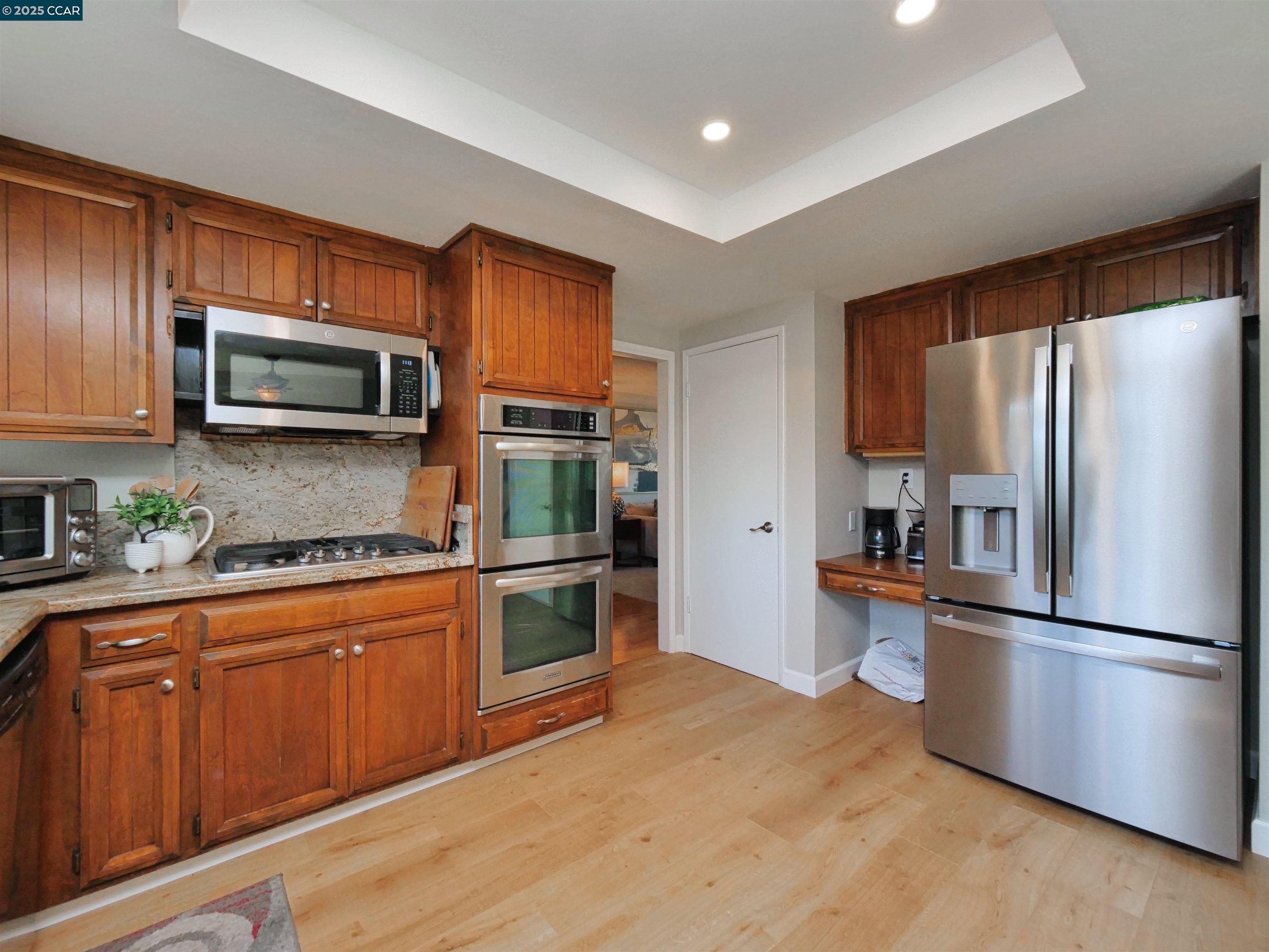 4044 Cowell Road Concord, CA 94518 - Photo 18 of 60 a kitchen with granite countertop stainless steel appliances and wooden cabinets