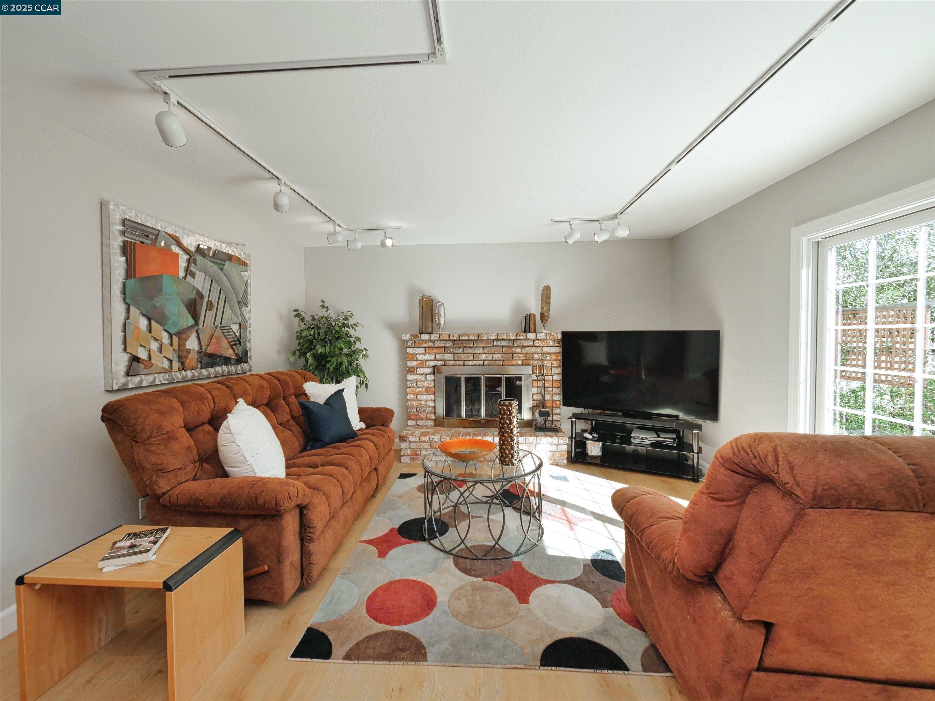 4044 Cowell Road Concord, CA 94518 - Photo 25 of 60 a living room with furniture a flat screen tv and a fireplace