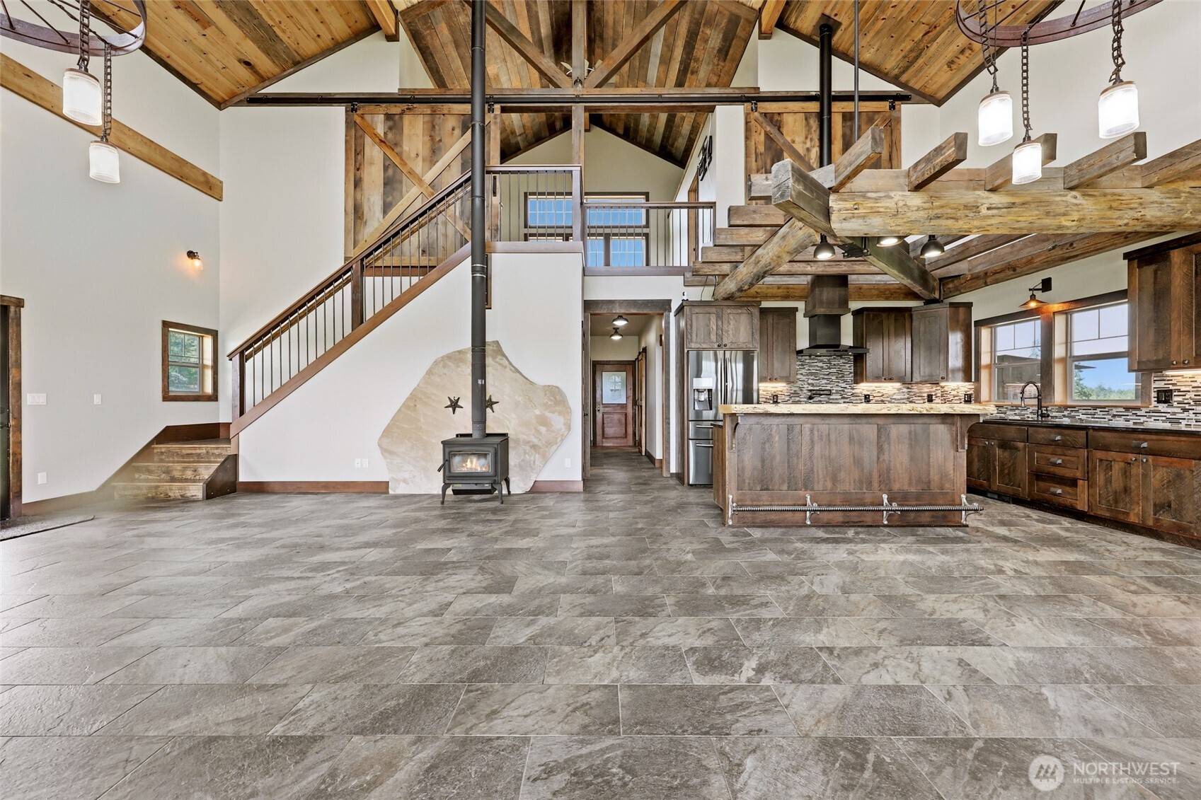 161 Northeast Belfair View Road Belfair, WA 98528 - Photo 13 of 40 a view of a big room with wooden floors and stairs