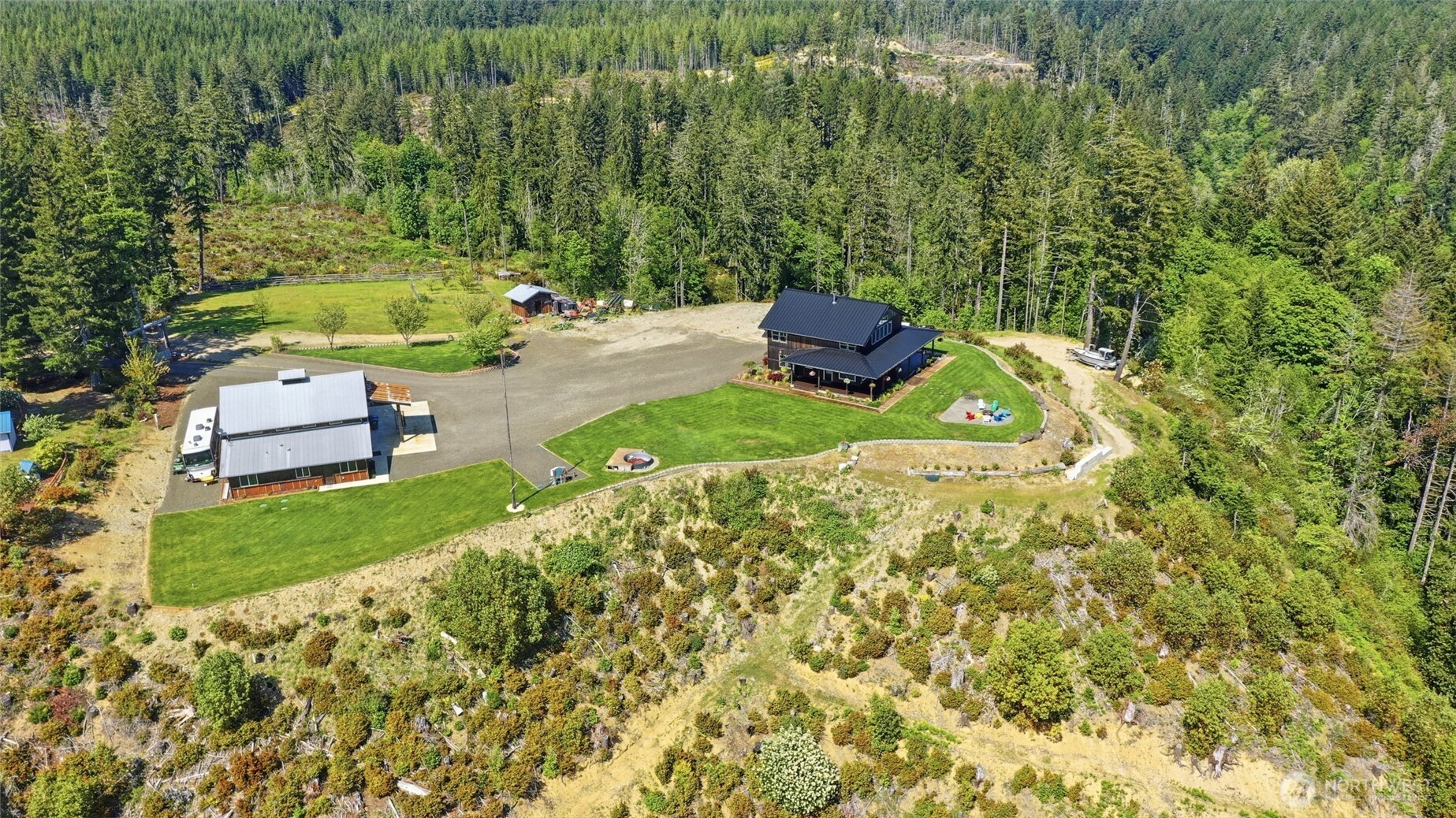 161 Northeast Belfair View Road Belfair, WA 98528 - Photo 6 of 40 a backyard of a house with a yard and outdoor seating