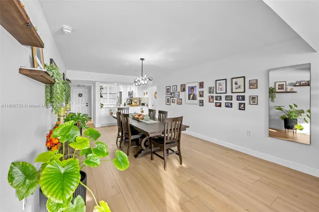 a view of a dining room with furniture and a potted plant