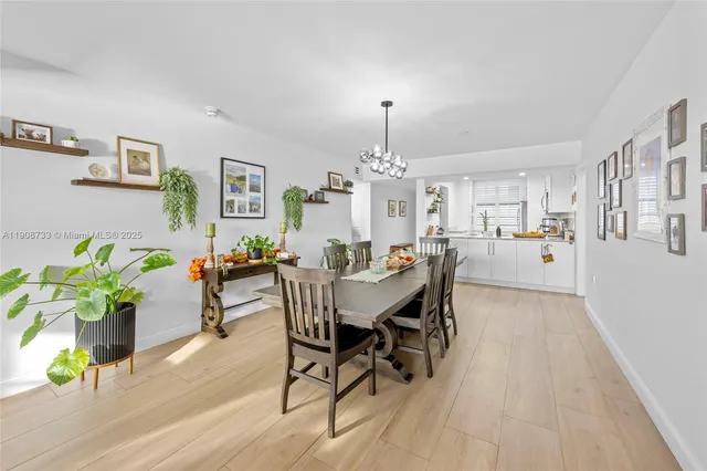 a view of a dining room with furniture and chandelier