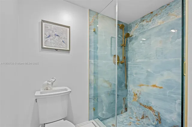 a bathroom with a shower a sink and toilet