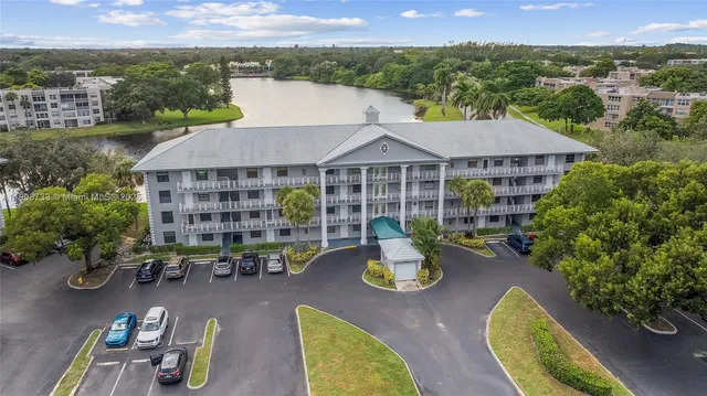 an aerial view of a house with swimming pool and patio
