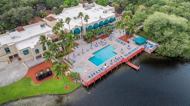 an aerial view of a pool with a yard