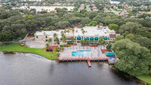 an aerial view of a house with a yard lake view and mountain view