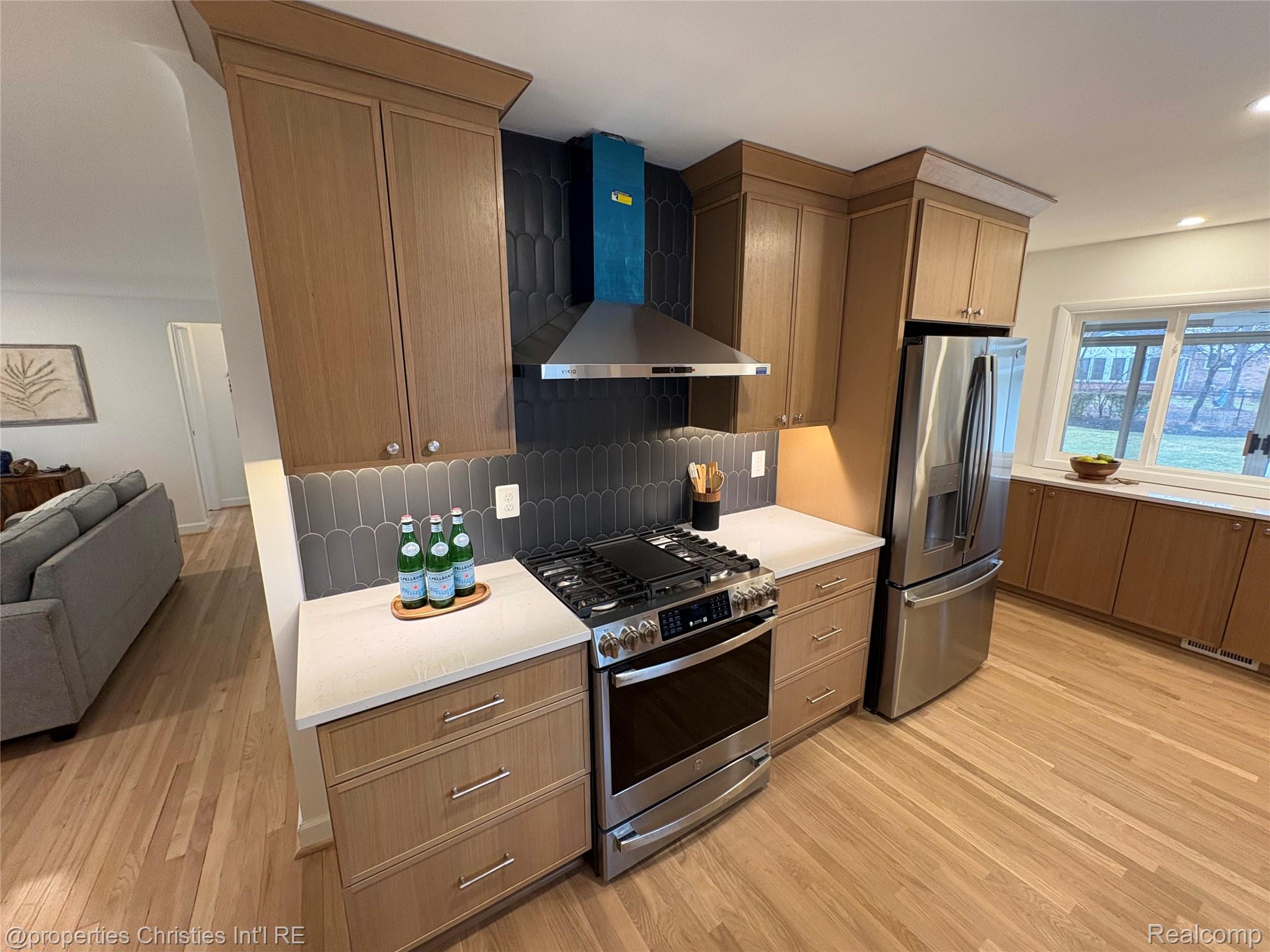 17330 Beverly Road Franklin, MI 48025 - Photo 24 of 24 Kitchen featuring stainless steel appliances, light wood finished floors, open floor plan, backsplash, and recessed lighting