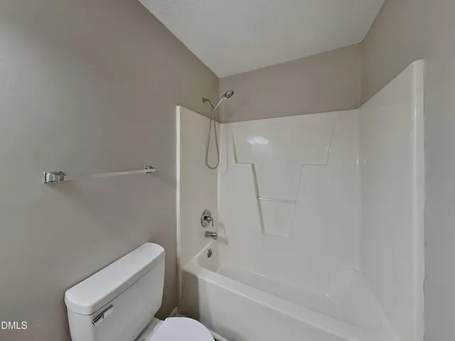 a bathroom with a toilet and a bathtub