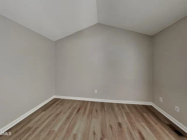 a view of an empty room and wooden floor