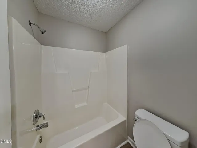 a bathroom with a toilet and bathtub