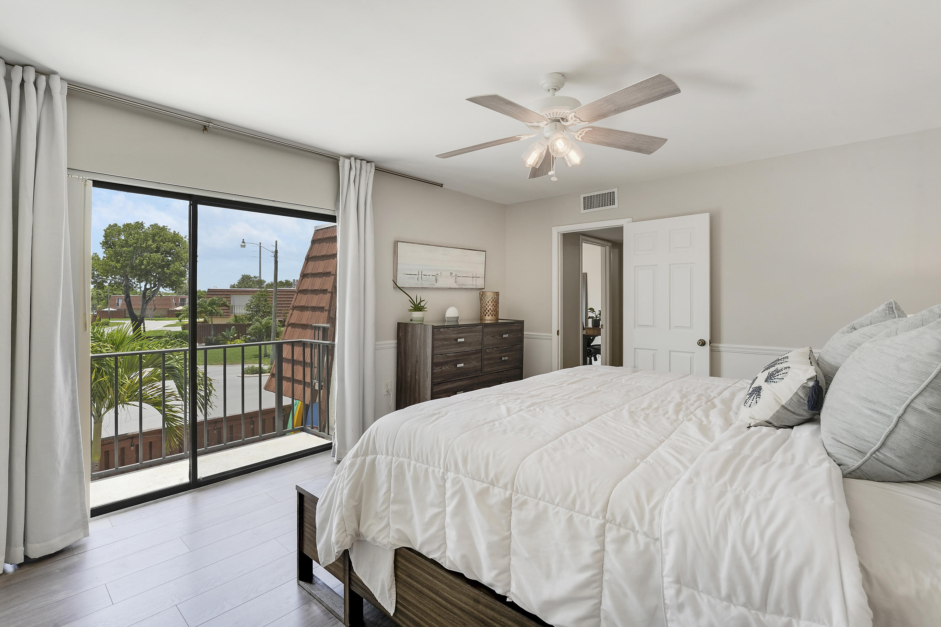 3900 County Line Road, Unit 4C Tequesta, FL 33469 - Photo 14 of 41 a bedroom with a large bed and a large window