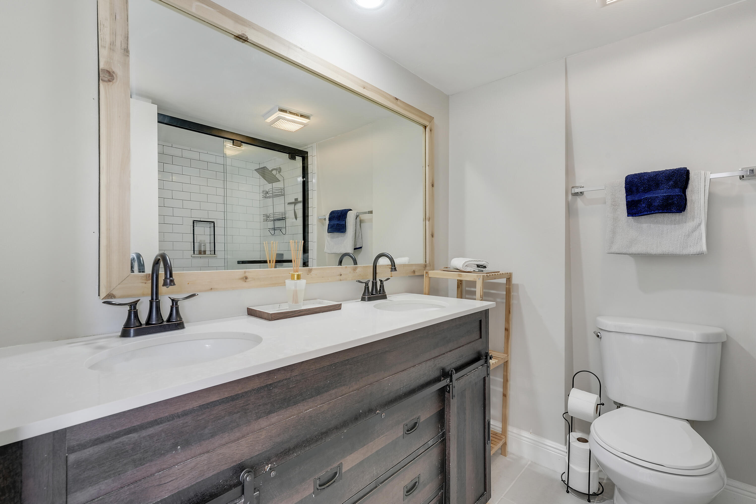 3900 County Line Road, Unit 4C Tequesta, FL 33469 - Photo 15 of 41 a bathroom with a sink a toilet and mirror