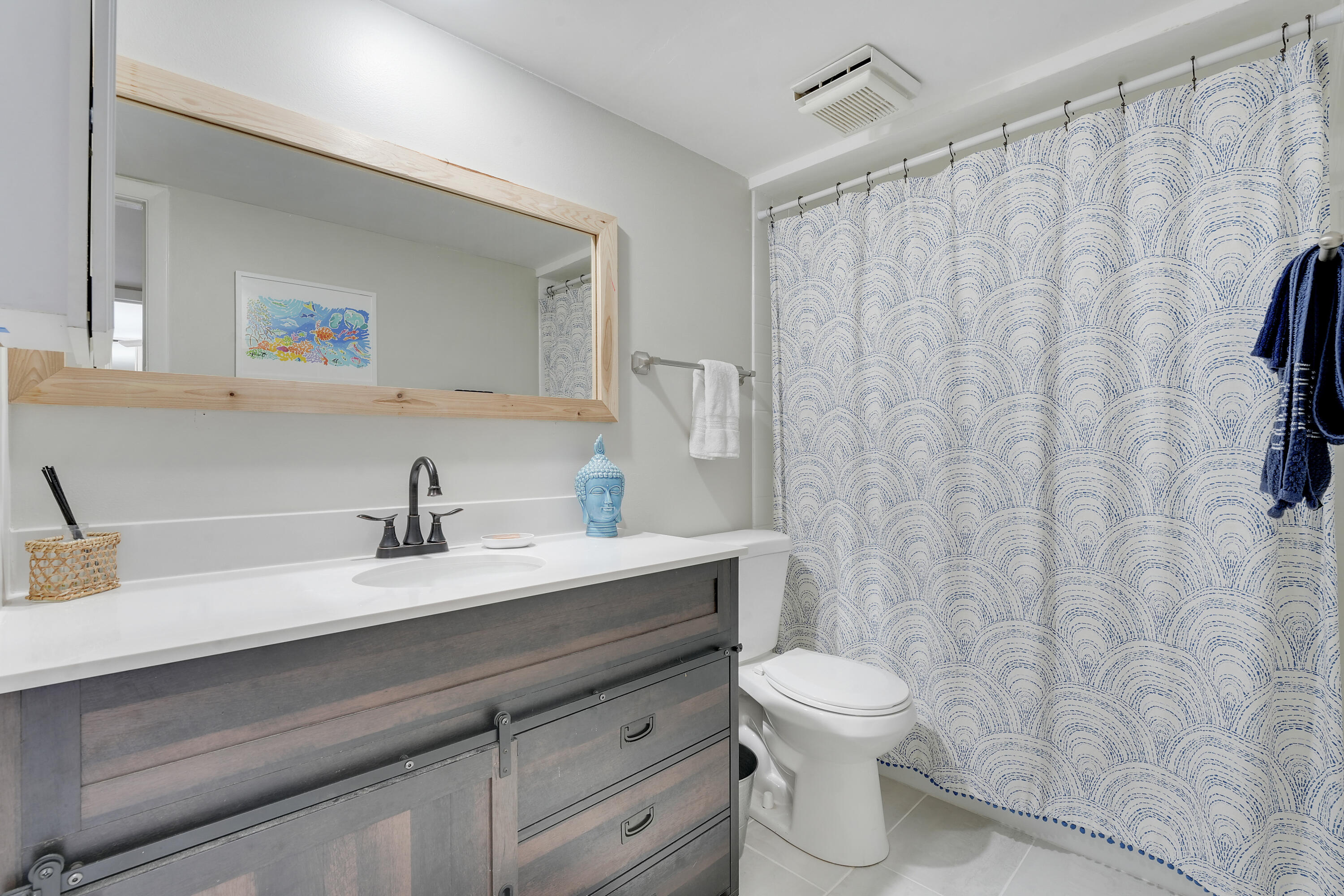 3900 County Line Road, Unit 4C Tequesta, FL 33469 - Photo 19 of 41 a bathroom with a granite countertop sink a toilet and a mirror