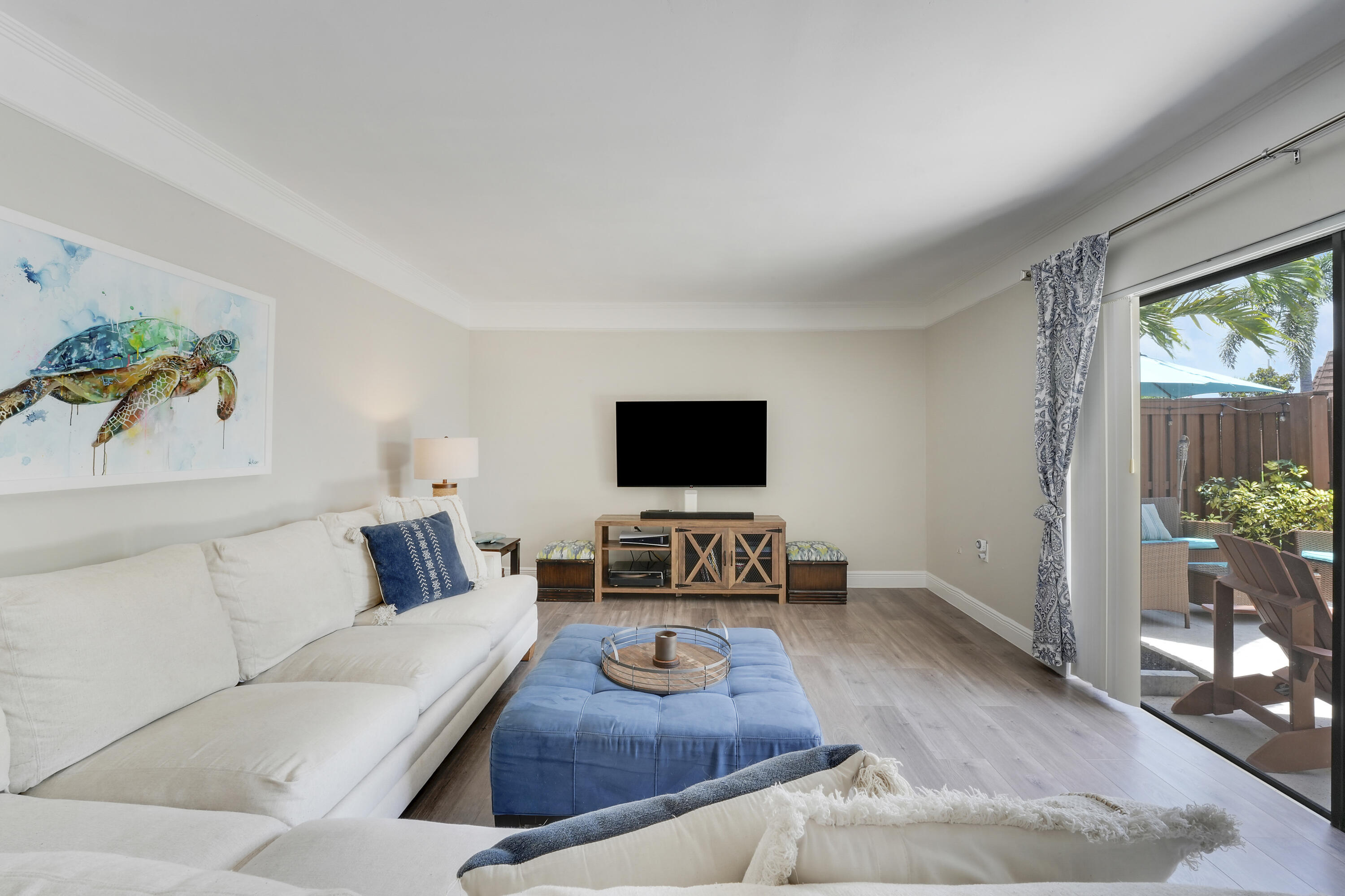 3900 County Line Road, Unit 4C Tequesta, FL 33469 - Photo 2 of 41 a living room with furniture and a flat screen tv
