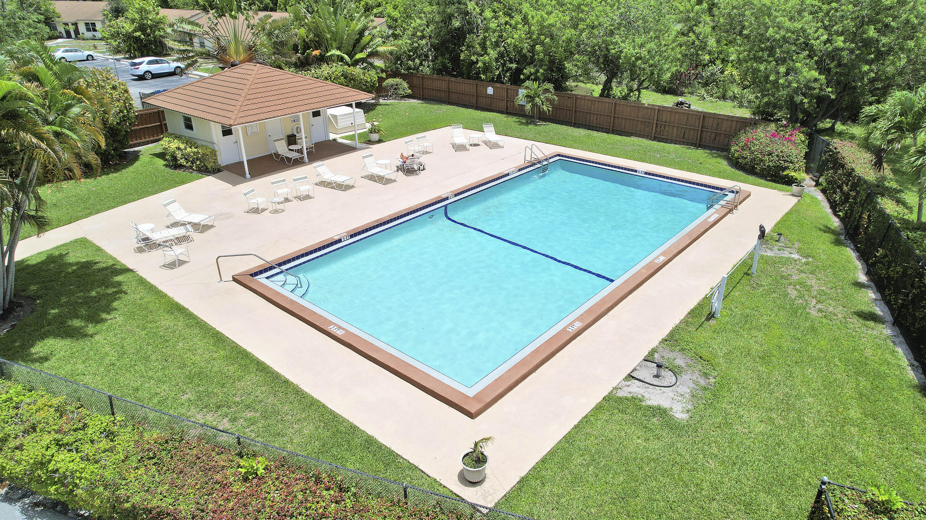 3900 County Line Road, Unit 4C Tequesta, FL 33469 - Photo 24 of 41 a view of a tennis ground with a swimming pool