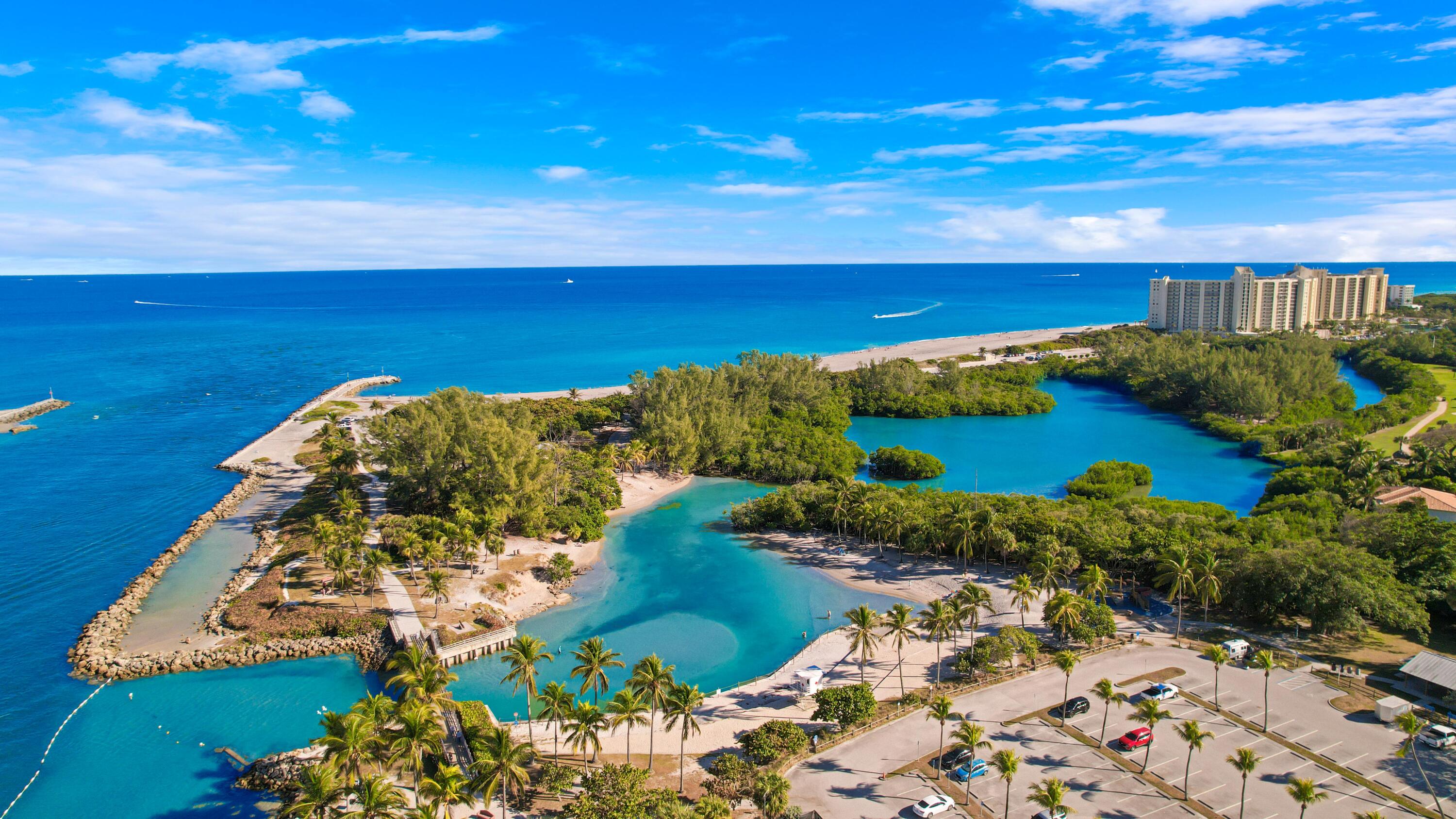 3900 County Line Road, Unit 4C Tequesta, FL 33469 - Photo 30 of 41 a view of a lake with a house in the background