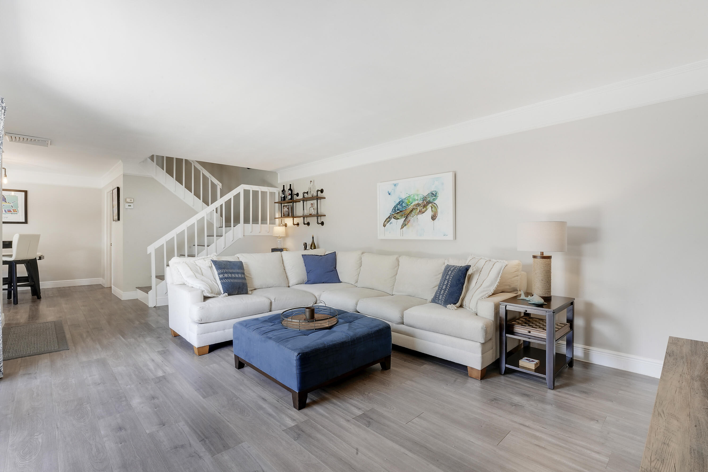 3900 County Line Road, Unit 4C Tequesta, FL 33469 - Photo 3 of 41 a living room with furniture and a wooden floor