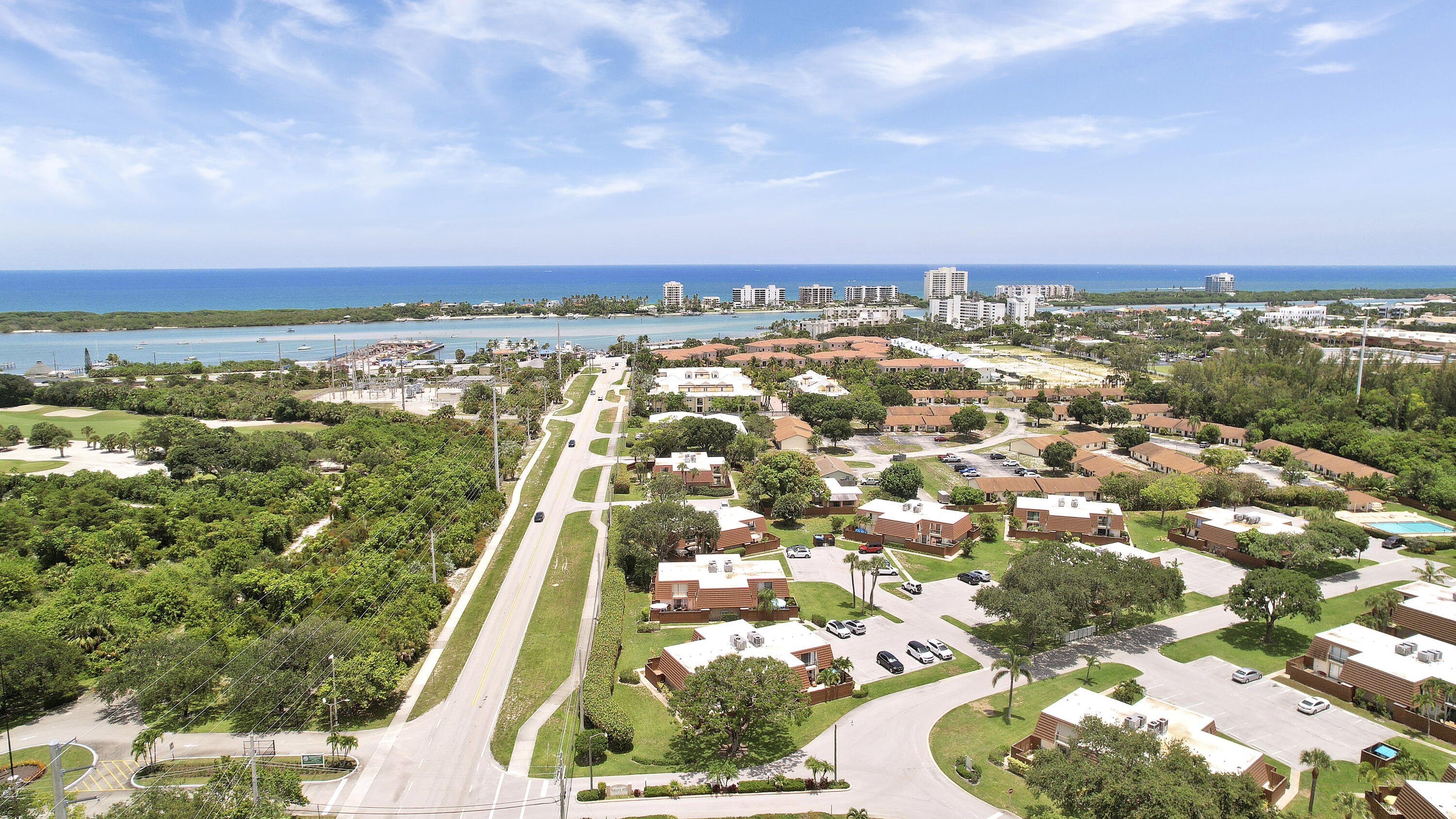 3900 County Line Road, Unit 4C Tequesta, FL 33469 - Photo 31 of 41 an aerial view of residential building with yard