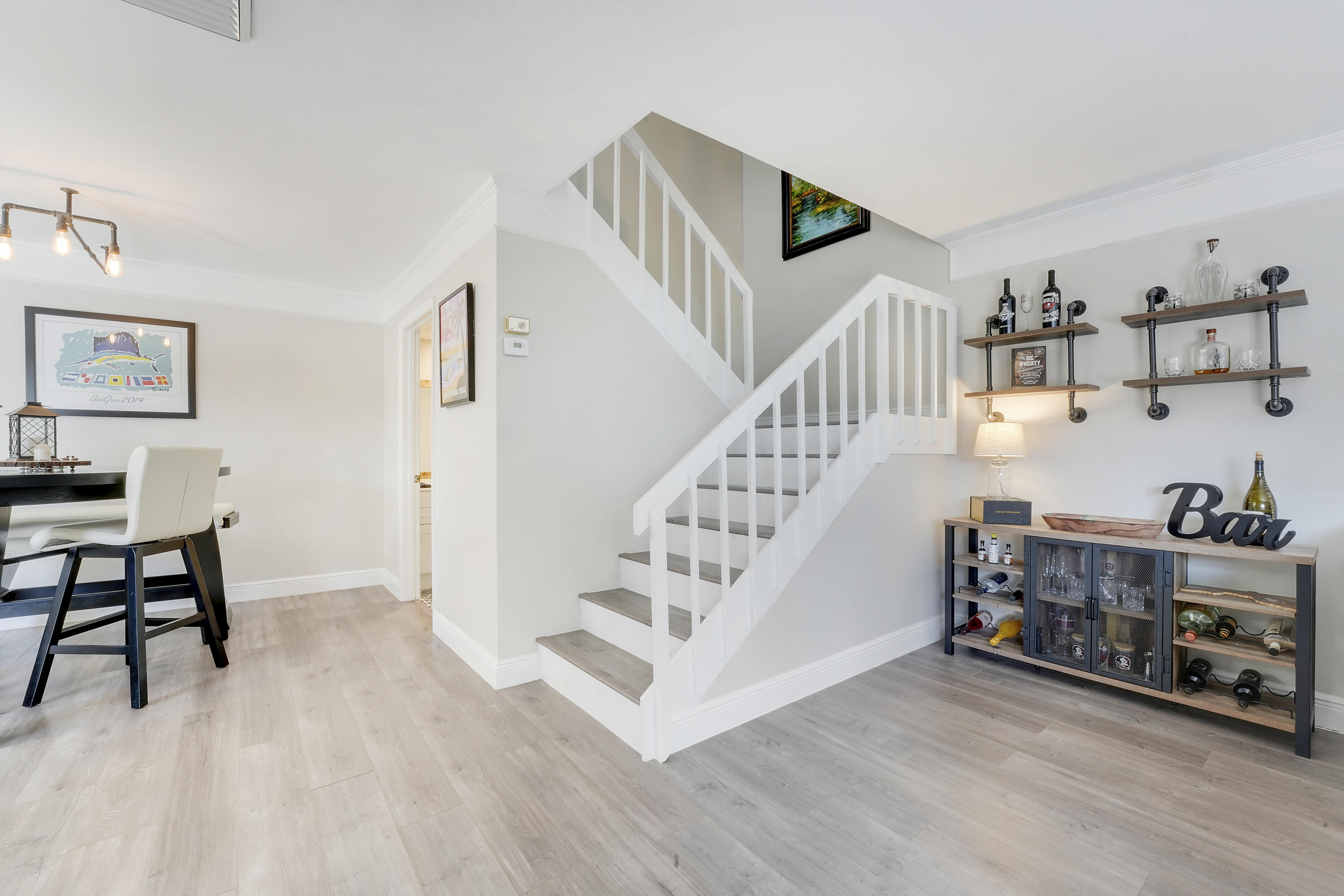 3900 County Line Road, Unit 4C Tequesta, FL 33469 - Photo 5 of 41 a view of entryway and hall with wooden floor