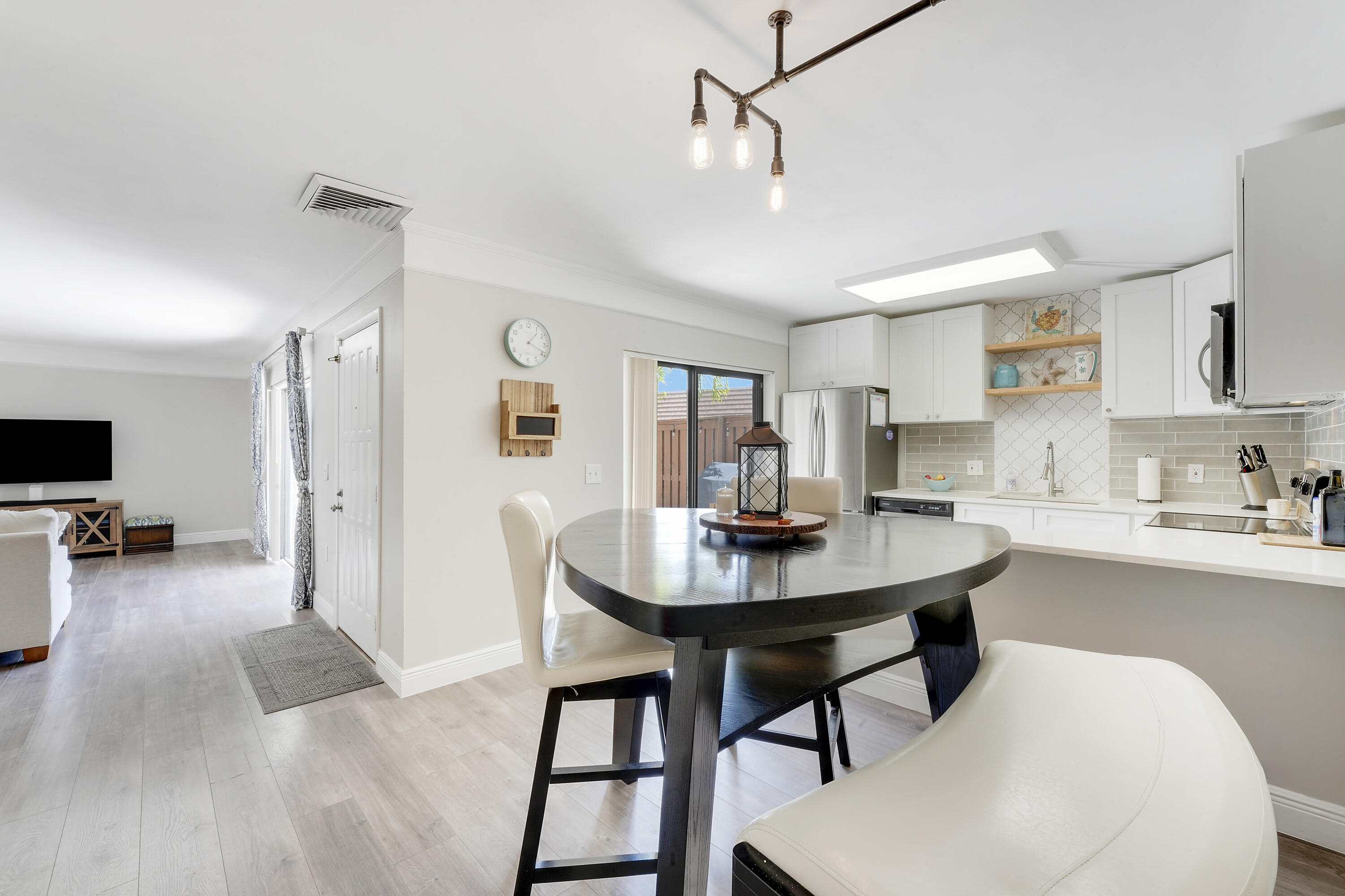 3900 County Line Road, Unit 4C Tequesta, FL 33469 - Photo 10 of 41 a view of a dining room with furniture and wooden floor