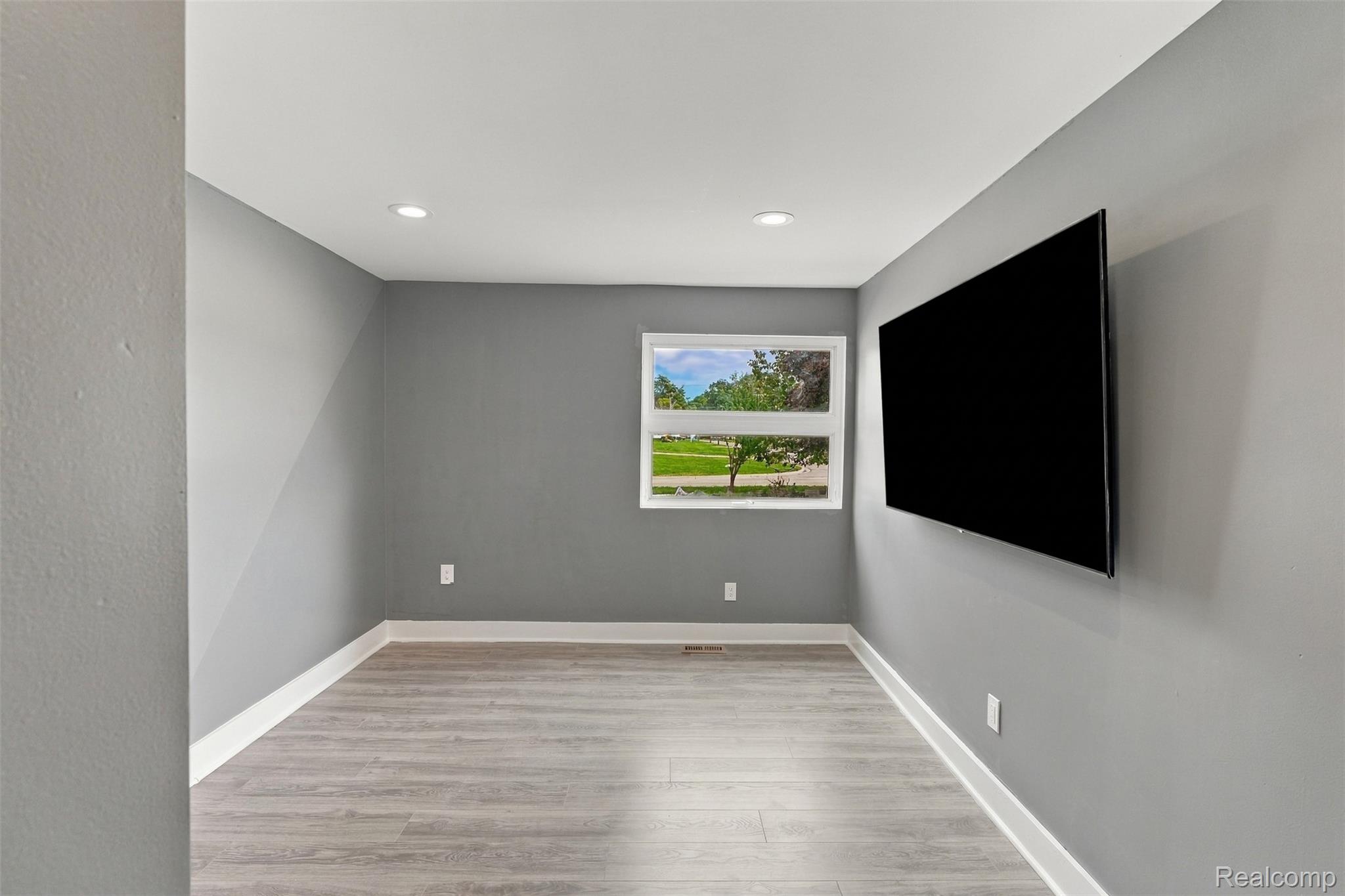 27507 Bell Road Southfield, MI 48034 - Photo 38 of 81 Recessed ceiling lighting, wood-finish flooring, white trim, and a window