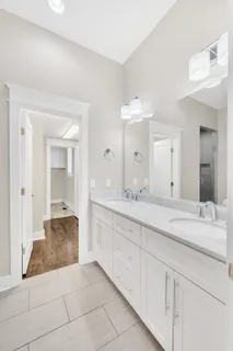 a spacious bathroom with a toilet sink and mirror