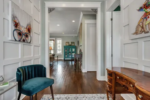 a living room with furniture and kitchen view