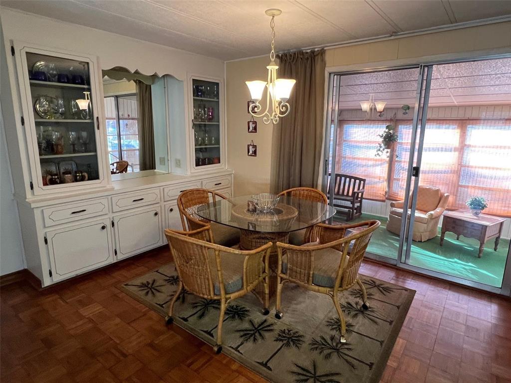 41 Royal Palm Circle Largo, FL 33778 - Photo 14 of 27 a dining room with furniture a chandelier and wooden floor