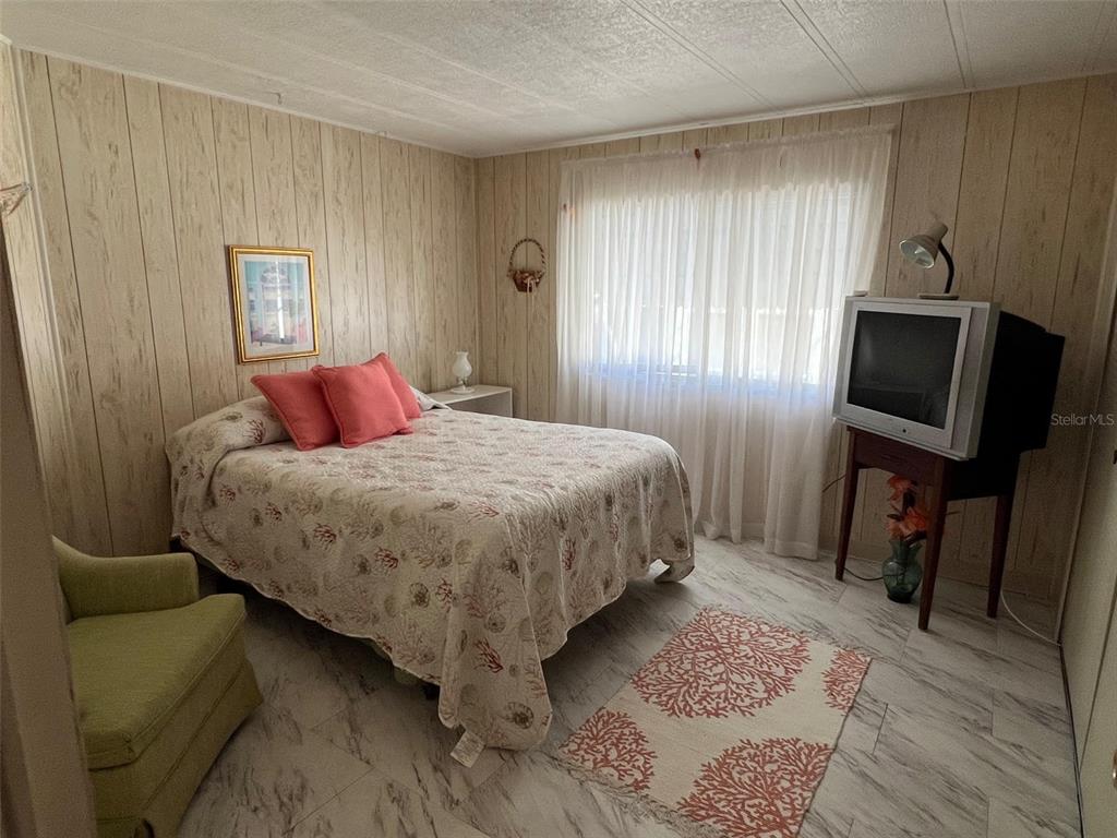 41 Royal Palm Circle Largo, FL 33778 - Photo 15 of 27 a bedroom with a bed and a television in it