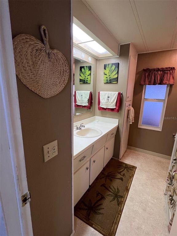 41 Royal Palm Circle Largo, FL 33778 - Photo 17 of 27 a spacious bathroom with a granite countertop sink and a mirror