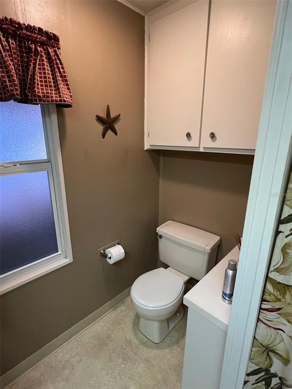 41 Royal Palm Circle Largo, FL 33778 - Photo 18 of 27 a white toilet sitting next to a bathroom sink
