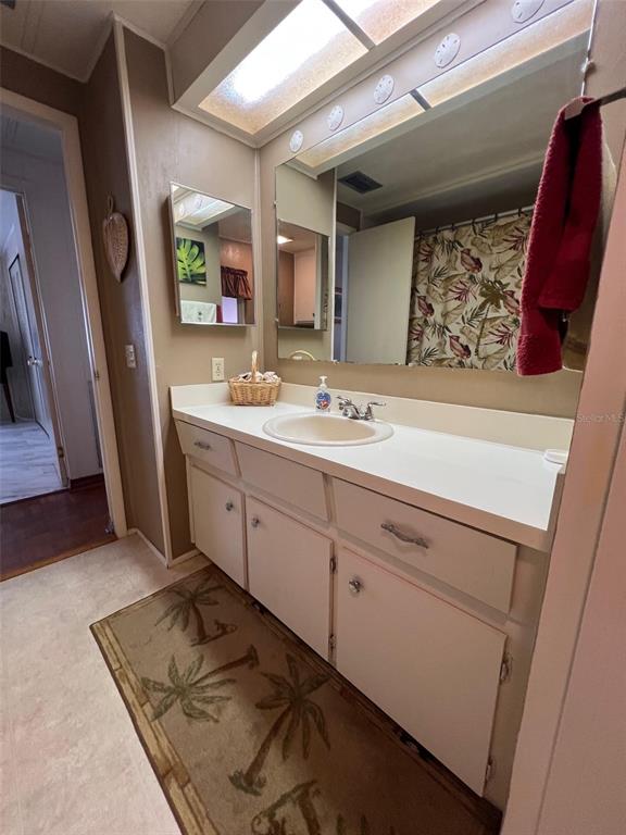 41 Royal Palm Circle Largo, FL 33778 - Photo 19 of 27 a spacious bathroom with a double vanity sink and a mirror