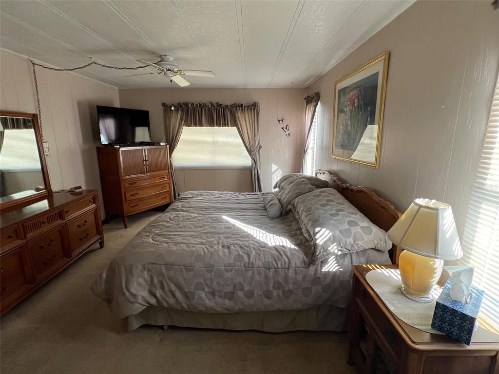 41 Royal Palm Circle Largo, FL 33778 - Photo 22 of 27 a bedroom with a bed and wooden floor