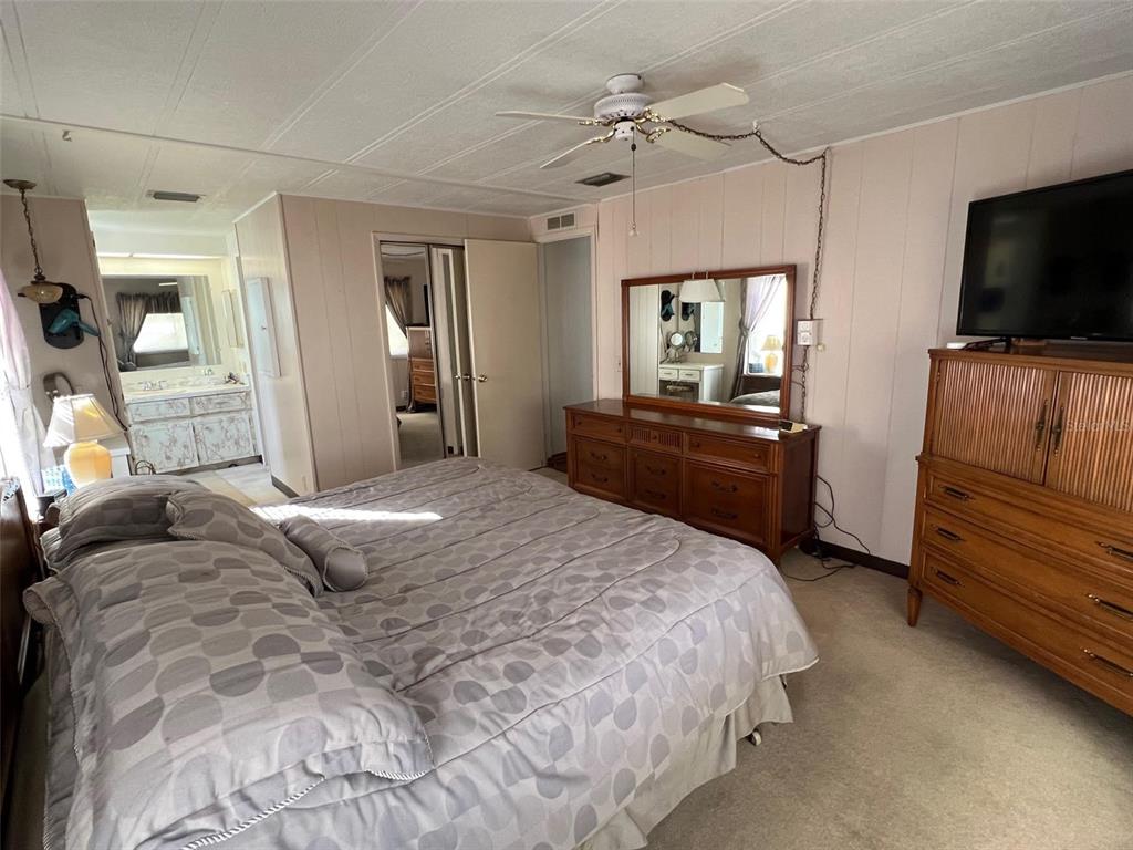 41 Royal Palm Circle Largo, FL 33778 - Photo 23 of 27 a bedroom with a bed and a flat screen tv