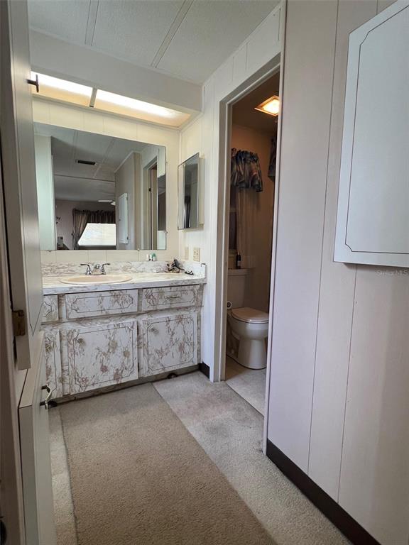 41 Royal Palm Circle Largo, FL 33778 - Photo 24 of 27 a room with a sink and a mirror