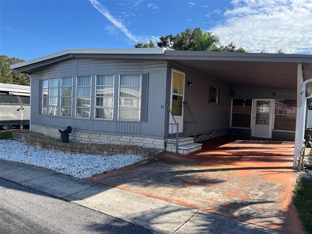 41 Royal Palm Circle Largo, FL 33778 - Photo 3 of 27 a front view of a house with porch