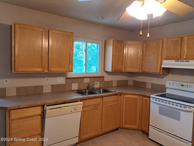 a kitchen with sink cabinets and window