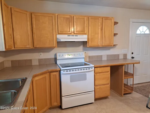 a kitchen with granite countertop cabinets stainless steel appliances and a counter space